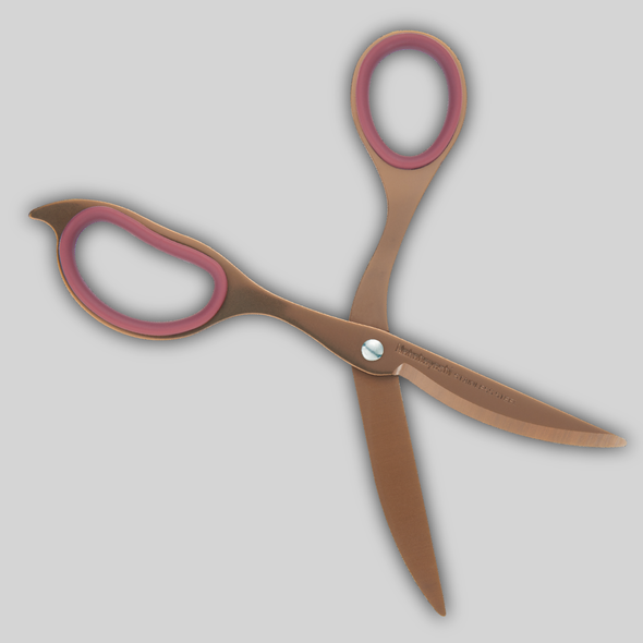 Cinnamon colored scissors with burgundy grips shown open