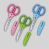 Group photo of Sakutto Cut scissors, blade-down in pink, green, and blue with blade covers nose-down.