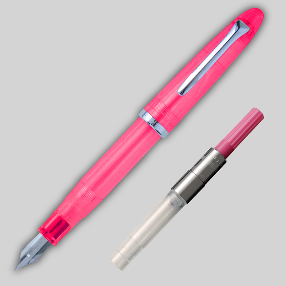Pink Sailor Compass 1911 Steel Fountain pen diagonally across page, showing matching color converter alongside.