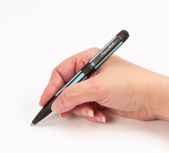 Black plated pen sits in hand being written with